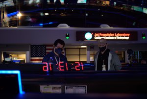 Members of NASA’s Perseverance Mars rover team study data on monitors in mission control, Thursday, Feb. 18, 2021, at NASA's Jet Propulsion Laboratory in Pasadena, California