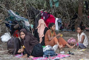 Ethnic Rohingya people rest on a beach after their boat was stranded on Idaman Island in East Aceh, Indonesia, Friday, June 4, 2021