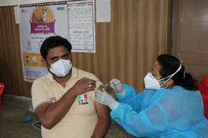 A medic inoculates a dose of COVID-19 vaccine amid the surge in coronavirus cases, at Gandhi health centre in Jammu, India, 31 May 2021.