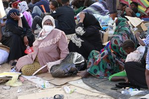 In this Oct. 9, 2021 file photo, dozens of migrants protest in front of the office of the United Nation's humanitarian body in Tripoli, Libya.