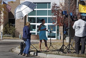 A broadcast journalist gives her live report outside the Santa Fe County Sheriff office in Santa Fe, N.M., Friday, Oct. 22, 2021. Actor Alec Baldwin fired a prop gun on the set of a Western being filmed at the Bonanza Creek Film Ranch in Santa Fe, on Thursday, Oct. 21, killing the cinematographer, officials said.