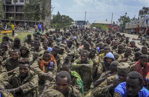 Captured Ethiopian government soldiers and allied militia members sit in rows, after being paraded by Tigray forces through the streets in open-top trucks, as they arrived to be taken to a detention center in Mekele, the capital of the Tigray region of northern Ethiopia Friday, Oct. 22, 2021. Ethiopian military airstrikes on Friday forced a United Nations humanitarian flight to abandon its landing in Mekele.