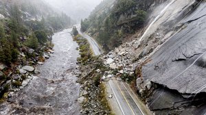 Rocks and vegetation cover Highway 70 following a landslide in the Dixie Fire zone on Sunday, Oct. 24, 2021, in Plumas County, California.