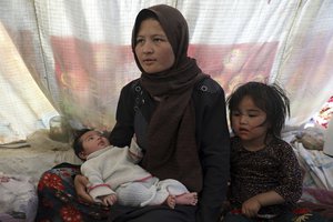 Fatima, an internally displaced Afghan woman who fled her home due to fighting between the Taliban and Afghan security personnel, speaks to The Associated press at a camp on the outskirts of Mazar-e-Sharif, northern Afghanistan, Thursday, July 8, 2021.