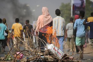 In this Monday Oct. 25, 2021 file photo, pro-democracy protesters use fires to block streets to condemn a takeover by military officials in Khartoum, Sudan