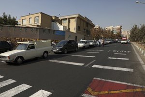 Cars wait in line to fill up at a gas station because pumps machines are out of service, in Tehran, Iran, Tuesday, Oct. 26, 2021.