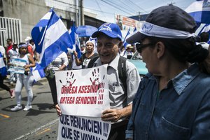 File - People with national flags during a protest against the government of President Daniel Ortega, Managua, Nicaragua