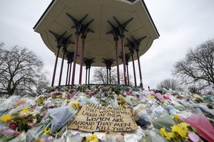 Floral tributes and messages are placed at the bandstand on Clapham Common in London, Saturday, March 20, 2021.