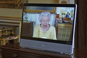 Queen Elizabeth II appears on a screen via videolink from Windsor Castle, where she is in residence, during a virtual audience at Buckingham Palace, London, Tuesday, Oct. 26, 2021.