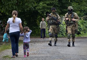 Ukrainian Government forces soldiers patrol the area at Bobovysche village near Mukacheve, Ukraine, Monday, July 13, 2015.