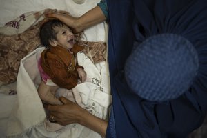 File - Sofia cradles her 2-month-old baby, Abdul, as he undergoes treatment at the malnutrition ward of the Indira Gandhi Children's Hospital in Kabul, Afghanistan, Tuesday, Oct. 5, 2021.