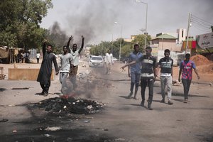 People burn tires during a protest a day after the military seized power Khartoum, Sudan, Tuesday, Oct. 26, 2021. The takeover came after weeks of mounting tensions between military and civilian leaders.