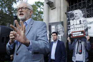 Former British Labour Party leader Jeremy Corbyn addresses Julian Assange supporters outside the High Court in London, Thursday, Oct. 28, 2021.