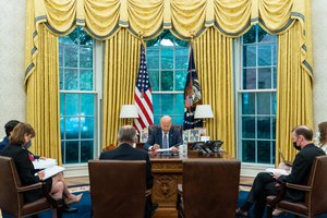 File - President Joe Biden meets with staff to review remarks he will deliver about the situation in Afghanistan, Friday, August 20, 2021, in the Oval Office of the White House.