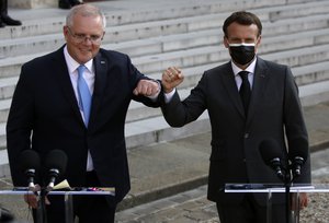 File - French President Emmanuel Macron, right, and Australia's Prime Minister Scott Morrison greet during a joint press conference with before a working dinner at the Elysee Palace in Paris, Tuesday, June 15, 2021.