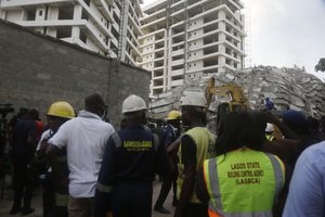 Rescue workers are seen at the site of a collapsed 21-story apartment building under construction in Lagos, Nigeria, Monday, Nov. 1, 2021