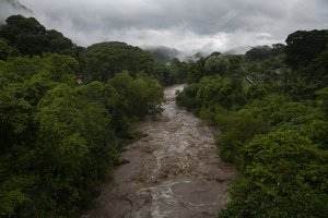 File - The swollen Los Esclavos River flows violently during tropical storm Amanda in Cuilapa, eastern Guatemala, Sunday, May 31, 2020.