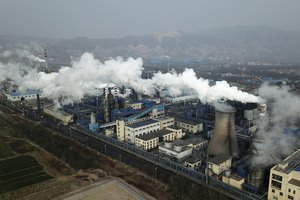 FILE - In this Nov. 28, 2019 file photo, smoke and steam rise from a coal processing plant in Hejin in central China's Shanxi Province.  (AP Photo/Sam McNeil, File)