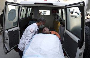 An injured man is put into an ambulance at a hospital in Kabul, Afghanistan, Thursday, March 7, 2019.