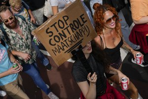 A placard reads "Stop the Control Society" during a protest of organizers and fans of music festivals stage against the government's COVID-19 restrictions on large-scale outdoor events in Amsterdam, Netherlands, Saturday, Sept. 11, 2021