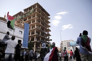 People chant slogans inside a building under construction during a protest in Khartoum, Sudan, Saturday, Oct. 30, 2021.