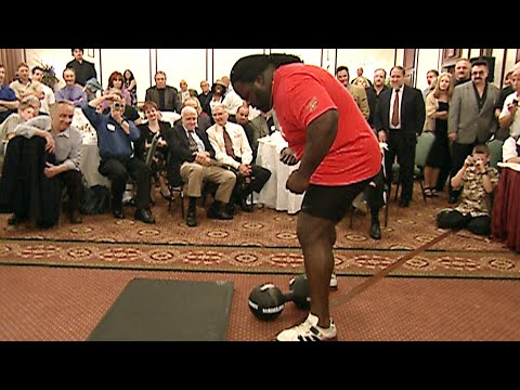 Mark Henry attempts to lift the legendary Thomas Inch Dumbbell with one hand (WWE Network)