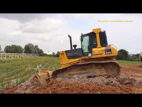 Bulldozer Pushing Dirt And Dump Truck Unloading Dirt