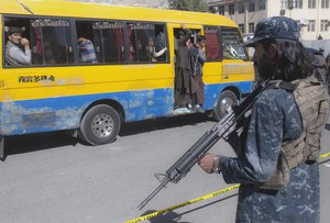 Taliban fighters stand guard after an explosion in Kabul, Afghanistan, Wednesday, Oct.20, 2021.