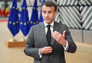 French President Emmanuel Macron talks to journalists during an EU summit at the European Council building in Brussels, Thursday, June 24, 2021