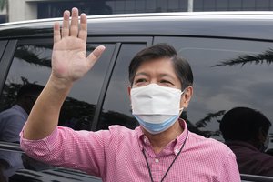 Former senator Ferdinand “Bongbong” Marcos Jr., center, waves to supporters after filing his certificate of candidacy for next year's presidential elections with the Commission on Elections at the Sofitel Harbor Garden Tent in Metropolitan Manila, Philippines on Wednesday, Oct. 6, 2021