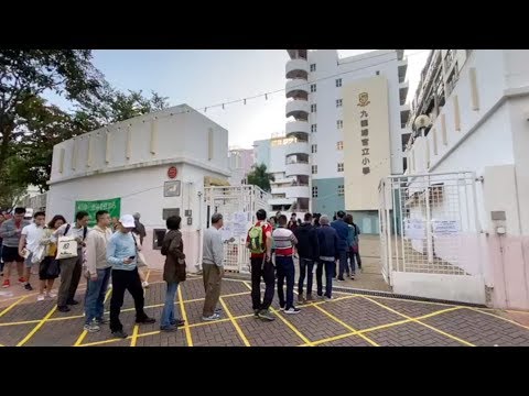 Electors line up to cast their ballots in Hong Kong District Council election