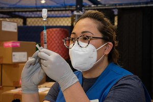 Laurei Fernandes,RN, American Red Cross volunteer draws the COVID-19 vaccine into a syringe for the dose of the Pfizer COVID-19 vaccine during a vaccine distribution at Commander, Fleet Activities Yokosuka’s (CFAY) Hawk’s Nest.