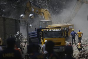 Rescue workers search for survivors in the rubble of the collapsed 21-story apartment building under construction in Lagos, Nigeria, Wednesday, Nov. 3, 2021.