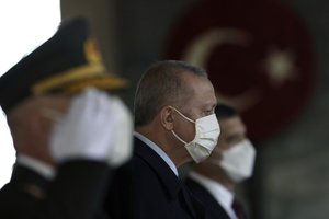 Turkey's President Recep Tayyip Erdogan stands with other Turkish leaders to lay a wreath at the mausoleum of modern Turkey's founder Mustafa Kemal Ataturk on Republic Day, in Ankara, Turkey, Friday, Oct. 29, 2021.