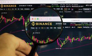 Binance logo on a computer screen with a magnifying glass