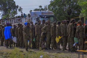 Captured Ethiopian government soldiers and allied militia members line up after being paraded by Tigray forces through the streets in open-top trucks, as they arrived to be taken to a detention center in Mekele, the capital of the Tigray region of northern Ethiopia Friday, Oct. 22, 2021.