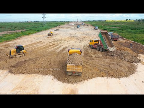 Dump trucks and bulldozers working | dump truck dumping dirt, bulldozer pushing dirt