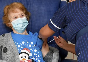 90 year old Margaret Keenan, the first patient in the UK to receive the Pfizer-BioNTech COVID-19 vaccine, administered by nurse May Parsons at University Hospital, Coventry, England, Tuesday Dec. 8, 2020