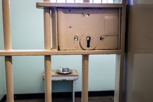 A prison or penitentiary holds people for longer periods of time, such as many years, and is operated by a state or federal government, Robben Island, South Africa.