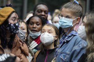 Climate activist Greta Thunberg, center, demonstrates in front of the Standard and Chartered Bank during a climate protest in London, England, Friday, Oct. 29, 2021