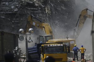 Rescue workers search for survivors in the rubble of the collapsed 21-story apartment building under construction in Lagos, Nigeria, Wednesday, Nov. 3, 2021