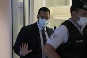 Alexandre Benalla, 30, a former security aide to President Emmanuel Macron leaves the court house on the first day of trial in Paris, Monday, Sept. 13, 2021