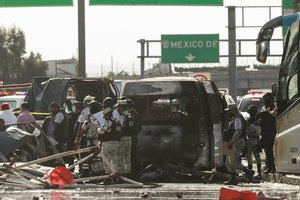 Rescue workers and firefighters work the scene of accident involving multiple vehicles, in Chalco, on the outskirt of Mexico City, Saturday, Nov. 6, 2021.