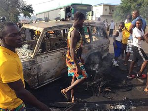 People gather at the scene of a tanker explosion after it was struck by a truck in the Wellington suburb of Sierra Leone's capital Freetown Saturday Nov. 6, 2021