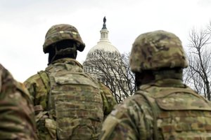 Soldiers and Airmen with the Virginia National Guard stand at attention at the U.S. Capitol during the 59th Presidential Inauguration in Washington, D.C., Jan. 20, 2021