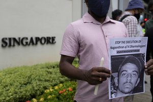 Activists attend a candlelight vigil against the impending execution of Nagaenthran K. Dharmalingam, sentenced to death for trafficking heroin into Singapore, outside the Singaporean embassy in Kuala Lumpur, Malaysia, Monday, Nov. 8, 2021