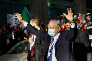 Mexican President Andres Manuel Lopez Obrador greets supporters as he departs to United Nations on Tuesday, Nov 9, 2021, in New York