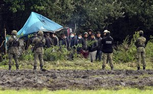 Polish security forces surround migrants stuck along with border with Belarus in Usnarz Gorny, Poland, on Wednesday, Sept. 1, 2021.