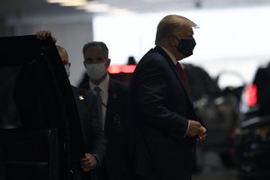 President Donald Trump steps out of his vehicle with a face mask on in New York