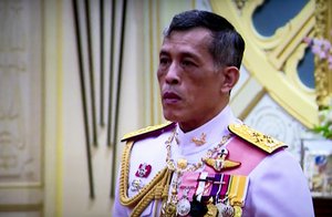 In this image made from video, Thailand's Crown Prince Maha Vajiralongkorn, listens to the invitation to ascend to the throne from National Legislative Assembly President Pornpetch Wichitcholchai, at the Grand Palace in Bangkok, Thailand,Thursday, Dec. 1, 2016. The new monarch, who received the title "His Majesty King Maha Vajiralongkorn Bodindradebayavarangkun," assumed his new position Thursday, according to an announcement broadcast on all TV channels. He will also be known as Rama X